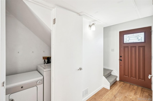 foyer with washing machine and dryer and light wood-type flooring