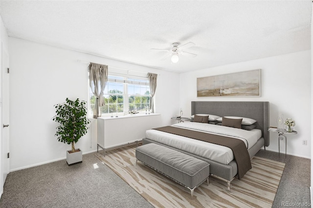 bedroom with carpet flooring, a textured ceiling, and ceiling fan