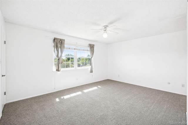 carpeted empty room featuring ceiling fan and a textured ceiling