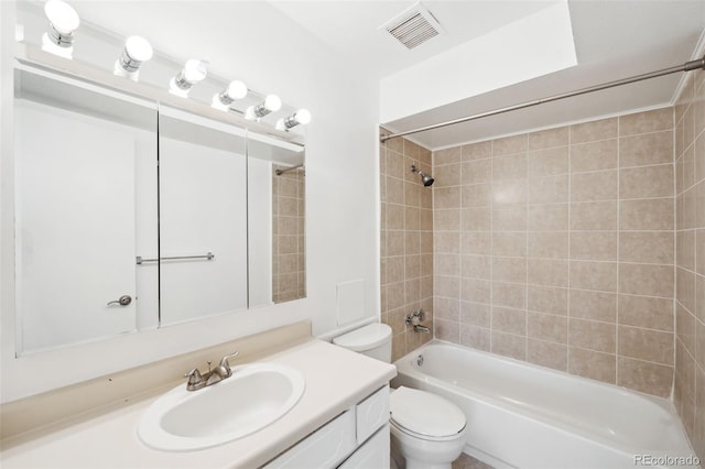 full bathroom featuring vanity, tiled shower / bath combo, and toilet