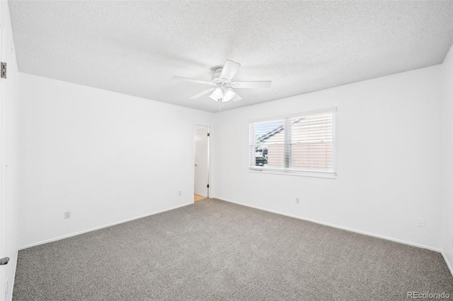 unfurnished room with carpet flooring, ceiling fan, and a textured ceiling