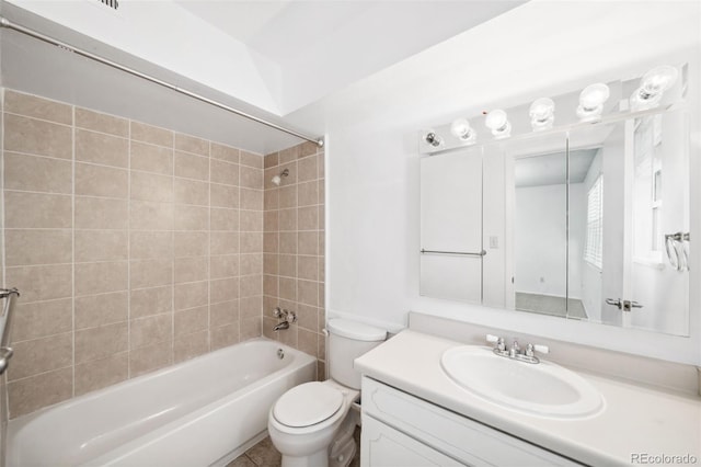 full bathroom with vanity, tiled shower / bath combo, and toilet