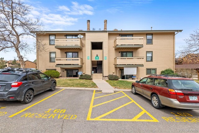 view of property with uncovered parking
