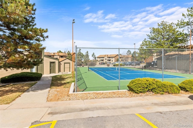 view of tennis court with fence