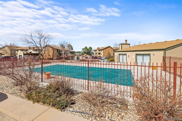 view of swimming pool featuring fence, a fenced in pool, a patio area, and a residential view