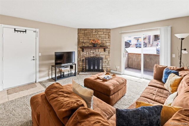 tiled living room with a fireplace and baseboards