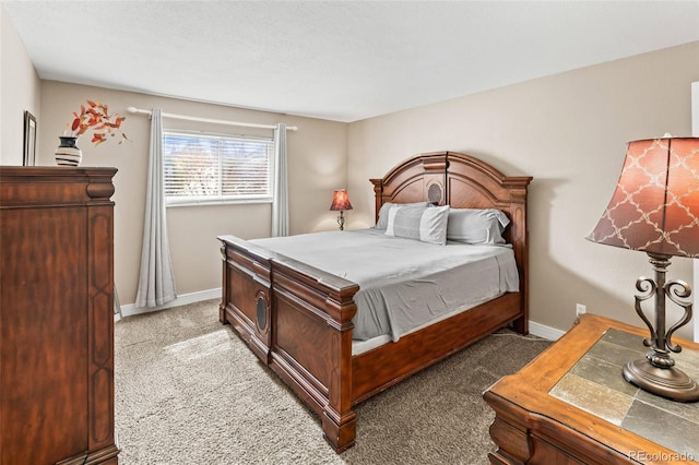 bedroom featuring light colored carpet and baseboards