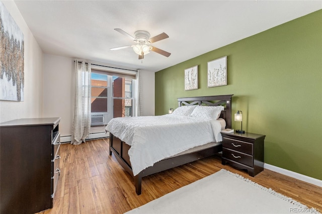 bedroom featuring cooling unit, ceiling fan, baseboards, and wood finished floors