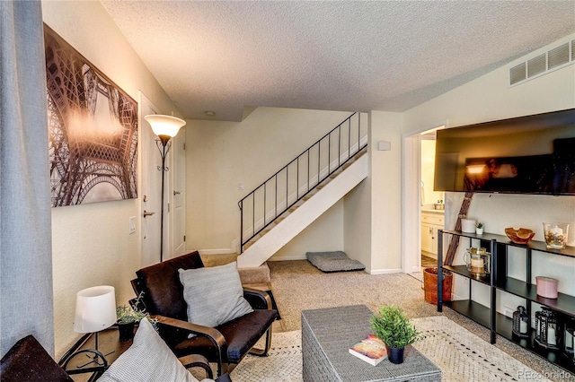 3572 S Kittredge St Unit B, Aurora, CO 80013 - carpeted living area with stairs and a textured ceiling