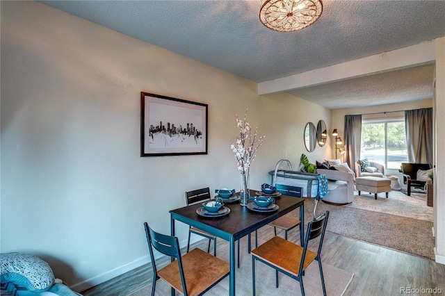 3572 S Kittredge St Unit B, Aurora, CO 80013 - dining area with a textured ceiling, wood finished floors, and beamed ceiling