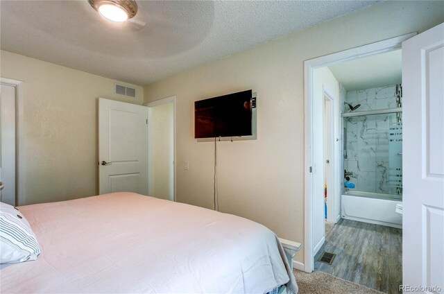 3572 S Kittredge St Unit B, Aurora, CO 80013 - bedroom featuring wood finished floors and connected bathroom