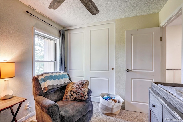 3572 S Kittredge St Unit B, Aurora, CO 80013 - sitting room featuring a textured ceiling, a textured wall, ceiling fan, and carpet floors