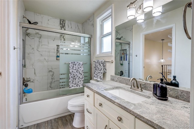 3572 S Kittredge St Unit B, Aurora, CO 80013 - full bathroom with vanity, bath / shower combo with glass door, and wood finished floors