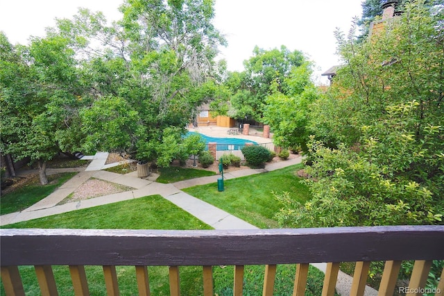 surrounding community featuring a swimming pool, a lawn, and a patio