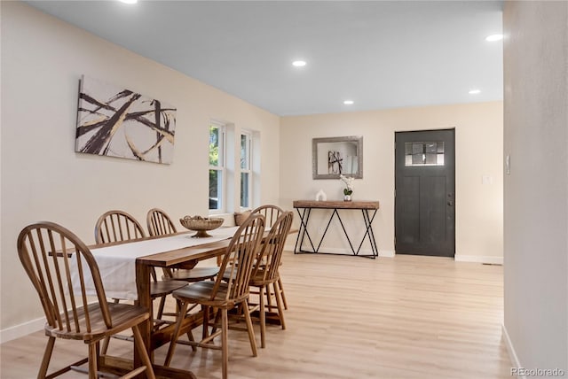 dining space with light hardwood / wood-style flooring