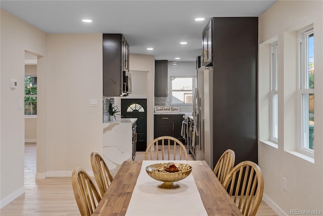 dining area with plenty of natural light and light hardwood / wood-style floors