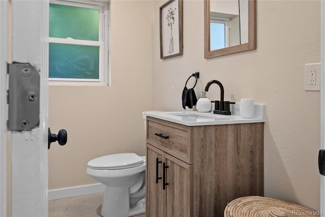 bathroom featuring toilet and vanity