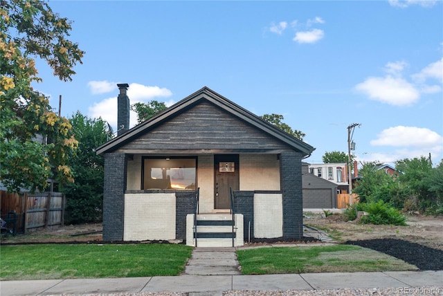 view of front of house featuring a garage and a front lawn