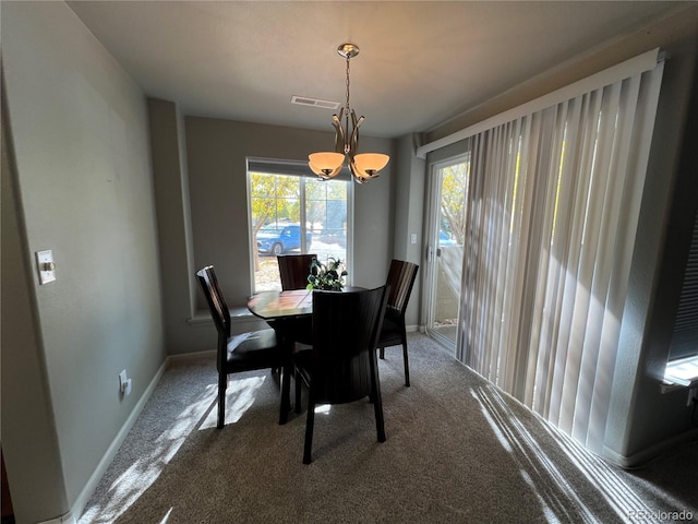 carpeted dining room with a wealth of natural light