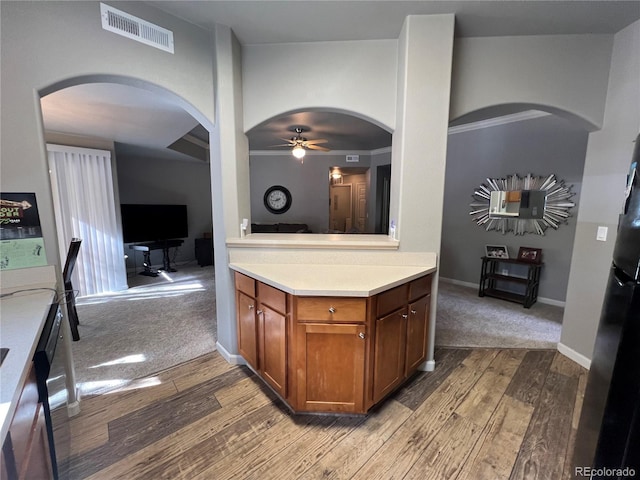 kitchen with light hardwood / wood-style floors, ceiling fan, and crown molding