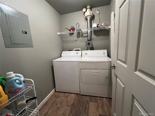 washroom with electric panel, washing machine and dryer, and dark hardwood / wood-style floors