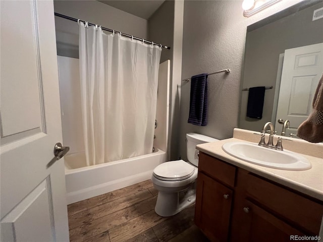 full bathroom featuring toilet, vanity, hardwood / wood-style floors, and shower / bathtub combination with curtain