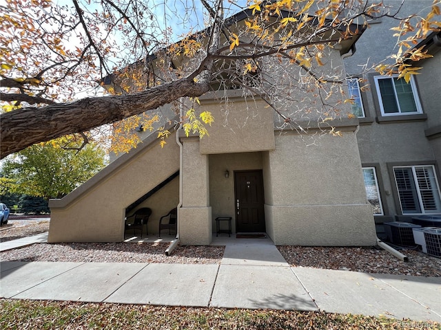 doorway to property featuring central air condition unit