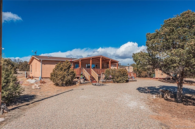 back of property with stairway and a wooden deck