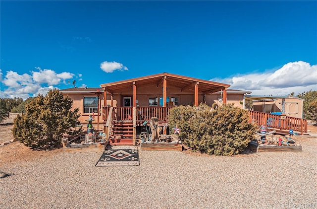 view of front of property with a deck and stucco siding