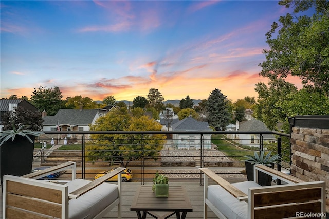 balcony at dusk with an outdoor hangout area