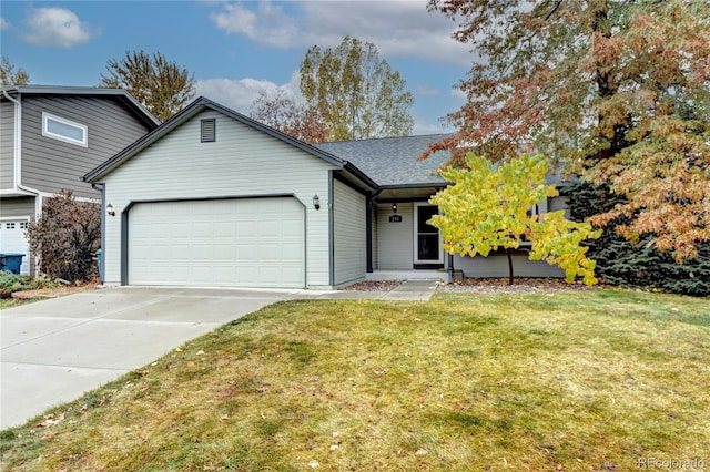 view of front of home featuring a garage and a front lawn