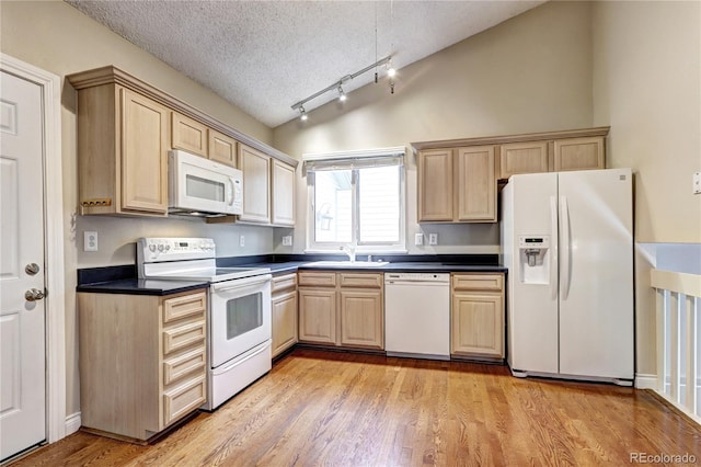 kitchen featuring light wood-type flooring, a textured ceiling, light brown cabinets, sink, and white appliances