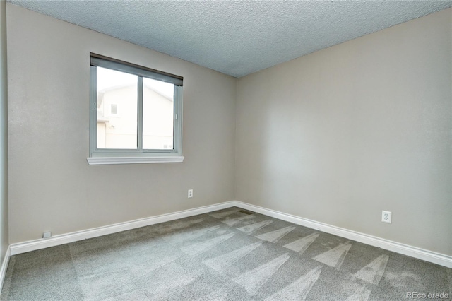 empty room featuring carpet flooring and a textured ceiling