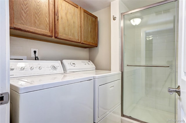 washroom with cabinets and independent washer and dryer