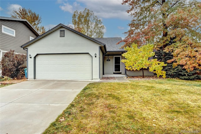 view of front of property featuring a garage and a front yard