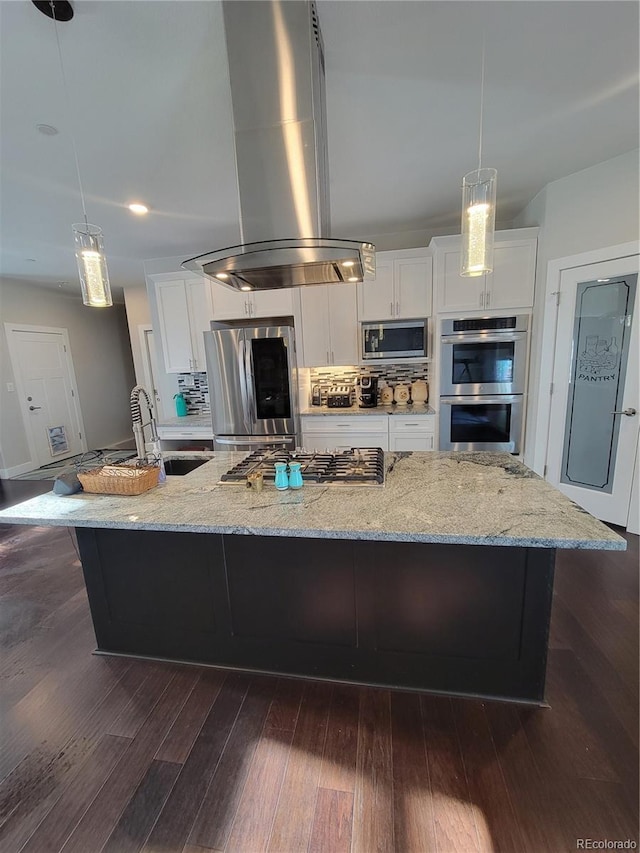 kitchen featuring stainless steel appliances, island exhaust hood, decorative light fixtures, and white cabinets