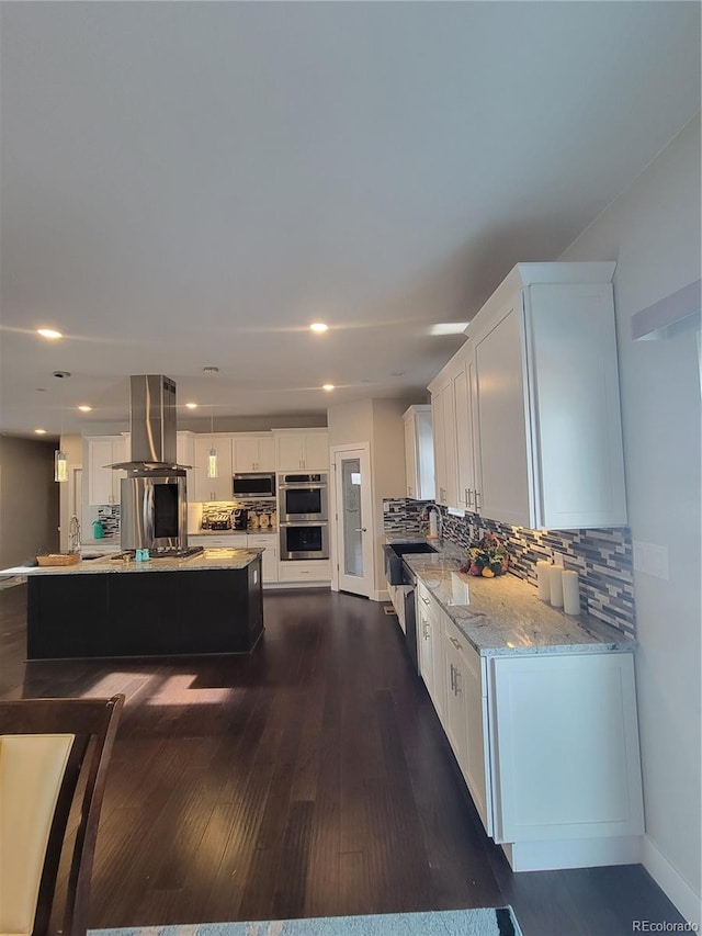 kitchen with a center island, decorative light fixtures, island exhaust hood, stainless steel appliances, and white cabinetry