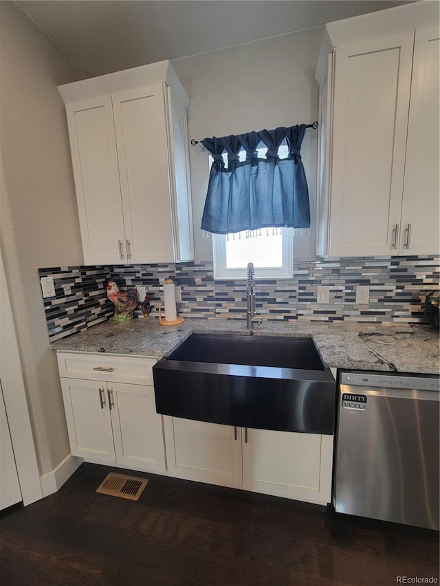 kitchen with a sink, visible vents, white cabinets, decorative backsplash, and dishwasher