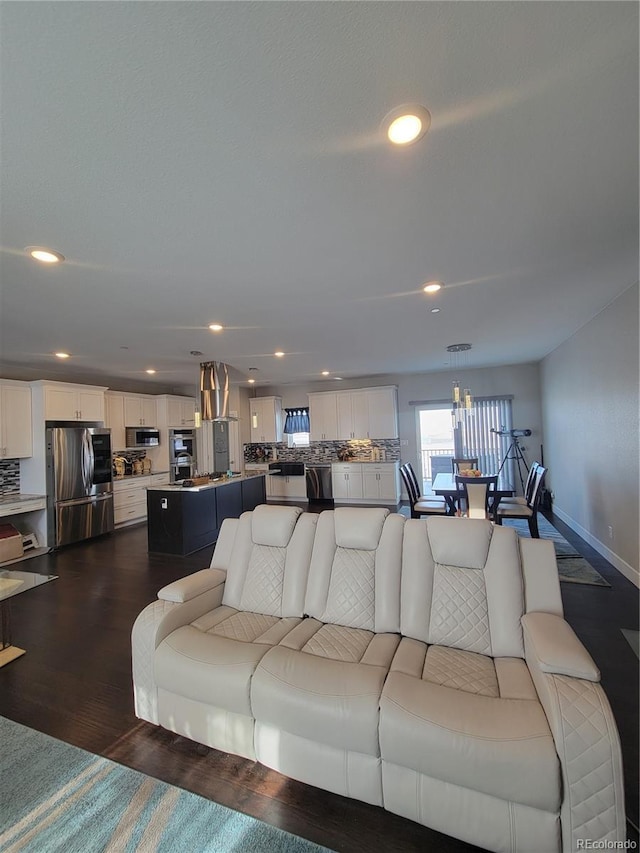 living room with baseboards, dark wood-style flooring, and recessed lighting