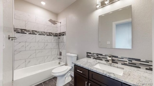 full bathroom with toilet, vanity, and bathing tub / shower combination