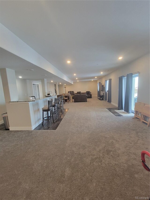 dining area with baseboards, dark colored carpet, and recessed lighting