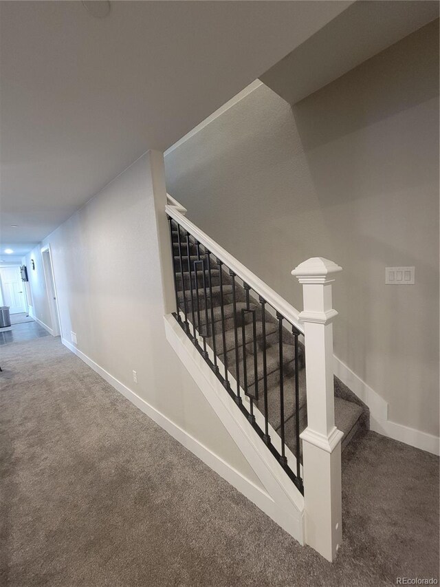 stairway with carpet and baseboards