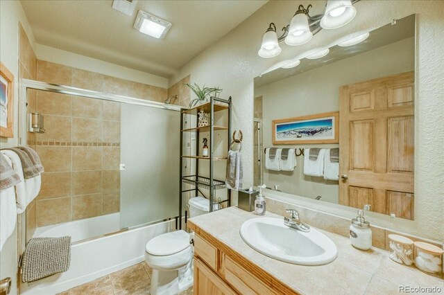 1387 Bobcat Ln, Fairplay, CO 80440 - full bathroom featuring vanity, bath / shower combo with glass door, and tile patterned floors