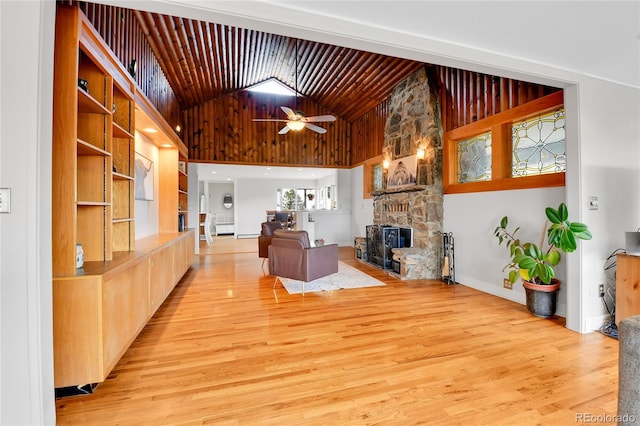 350 Tower Hill Cir, Golden, CO 80401 - living area with a stone fireplace, light wood-style floors, a ceiling fan, and high vaulted ceiling