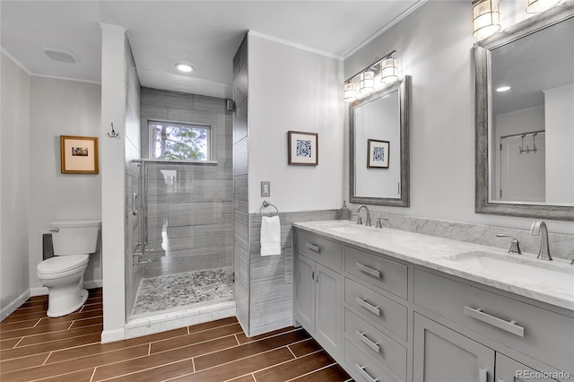 350 Tower Hill Cir, Golden, CO 80401 - bathroom featuring crown molding, wood finish floors, double vanity, a stall shower, and recessed lighting