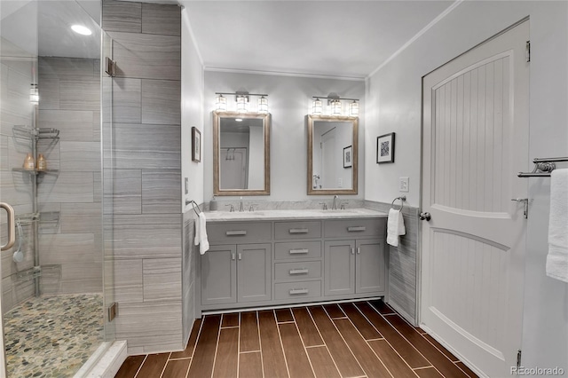 350 Tower Hill Cir, Golden, CO 80401 - full bathroom featuring double vanity, a stall shower, wood finish floors, and ornamental molding