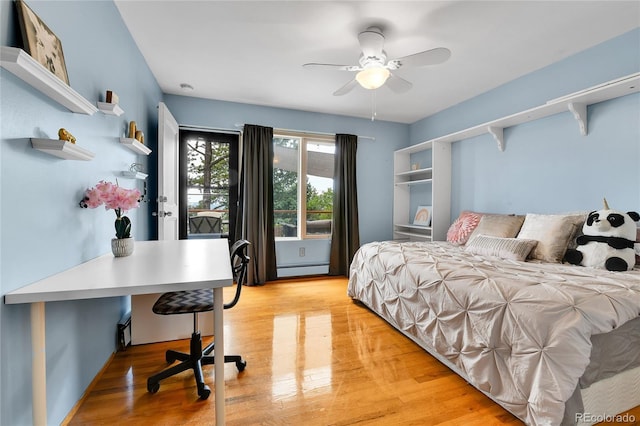 350 Tower Hill Cir, Golden, CO 80401 - bedroom featuring light wood-style floors, a baseboard heating unit, and a ceiling fan