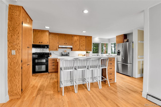 350 Tower Hill Cir, Golden, CO 80401 - kitchen with stainless steel appliances, range hood, under cabinet range hood, brown cabinets, and light countertops