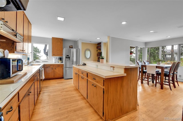 350 Tower Hill Cir, Golden, CO 80401 - kitchen featuring stainless steel appliances, a center island, light wood-style floors, healthy amount of natural light, and recessed lighting
