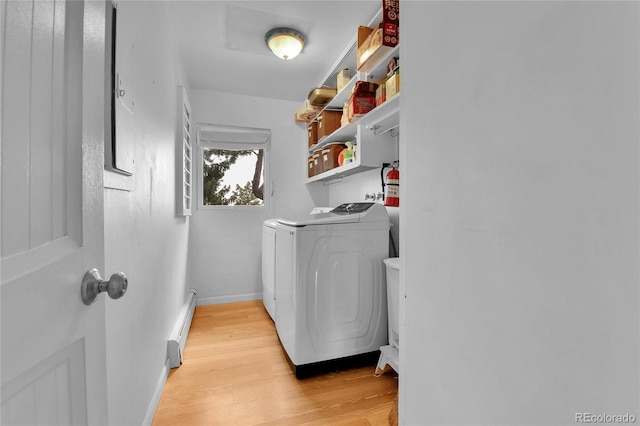350 Tower Hill Cir, Golden, CO 80401 - laundry room with baseboard heating, washing machine and dryer, and light wood finished floors